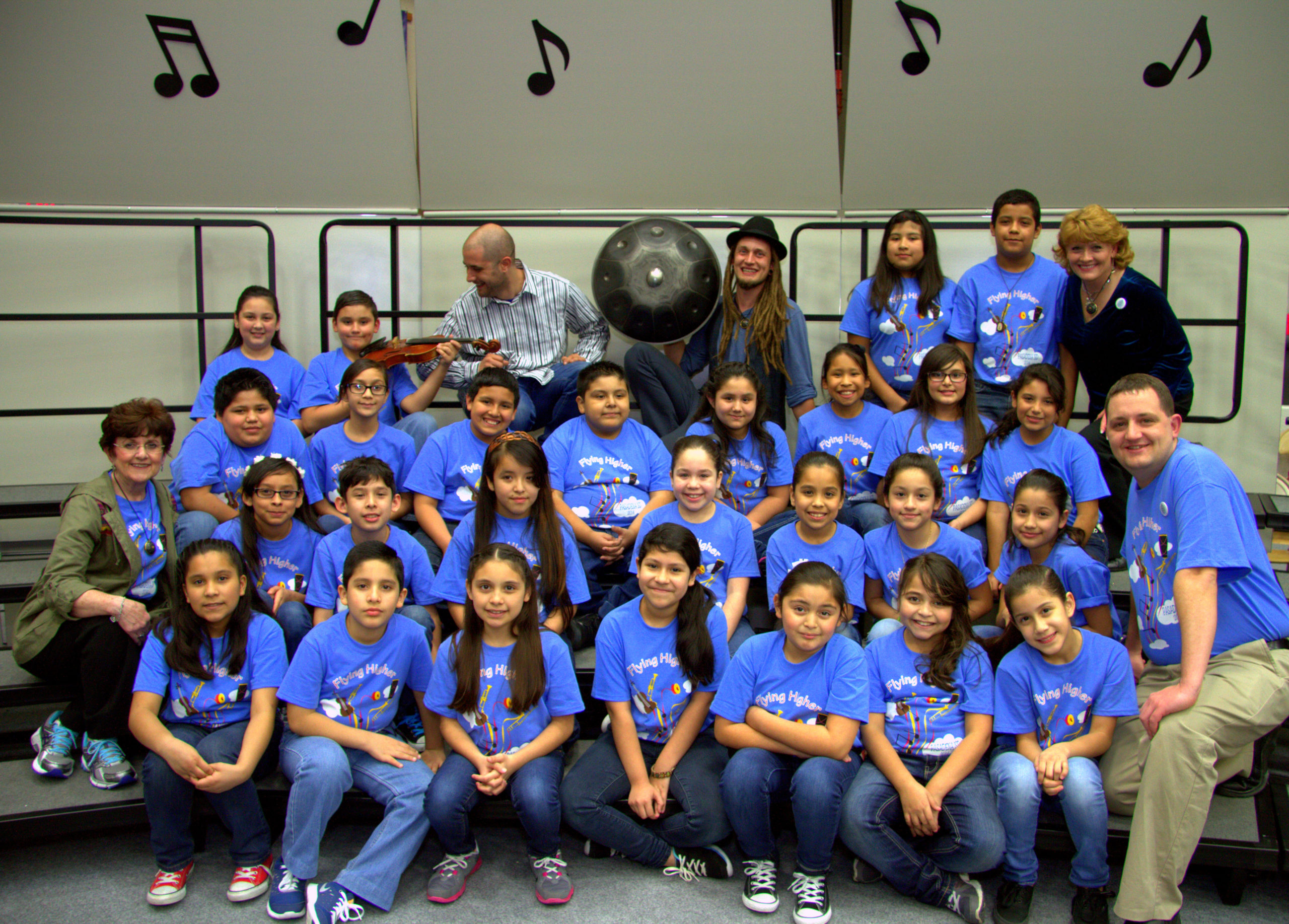 Seth Fewell directing the Pearl Hall Elementary choir with "Hang In Balance" musician Daniel Waples with his hang drum.